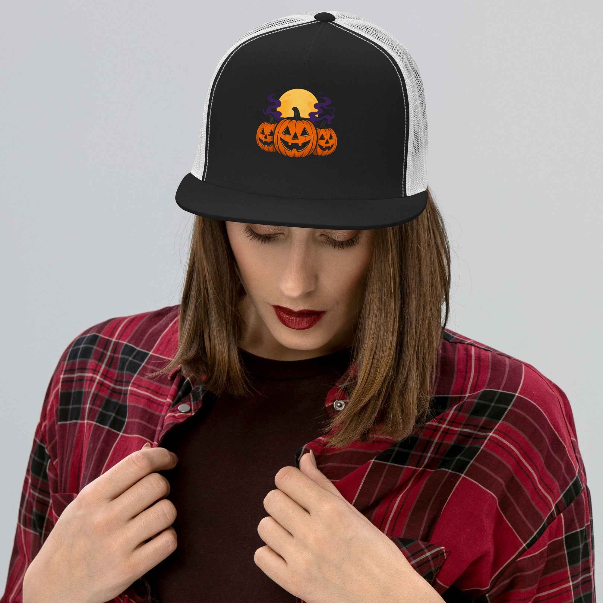 Model wearing Midnight Pumpkins: The Parade hat design from Rare Plus Apparel – radiant jack-o’-lanterns and moonlit retro Halloween style.