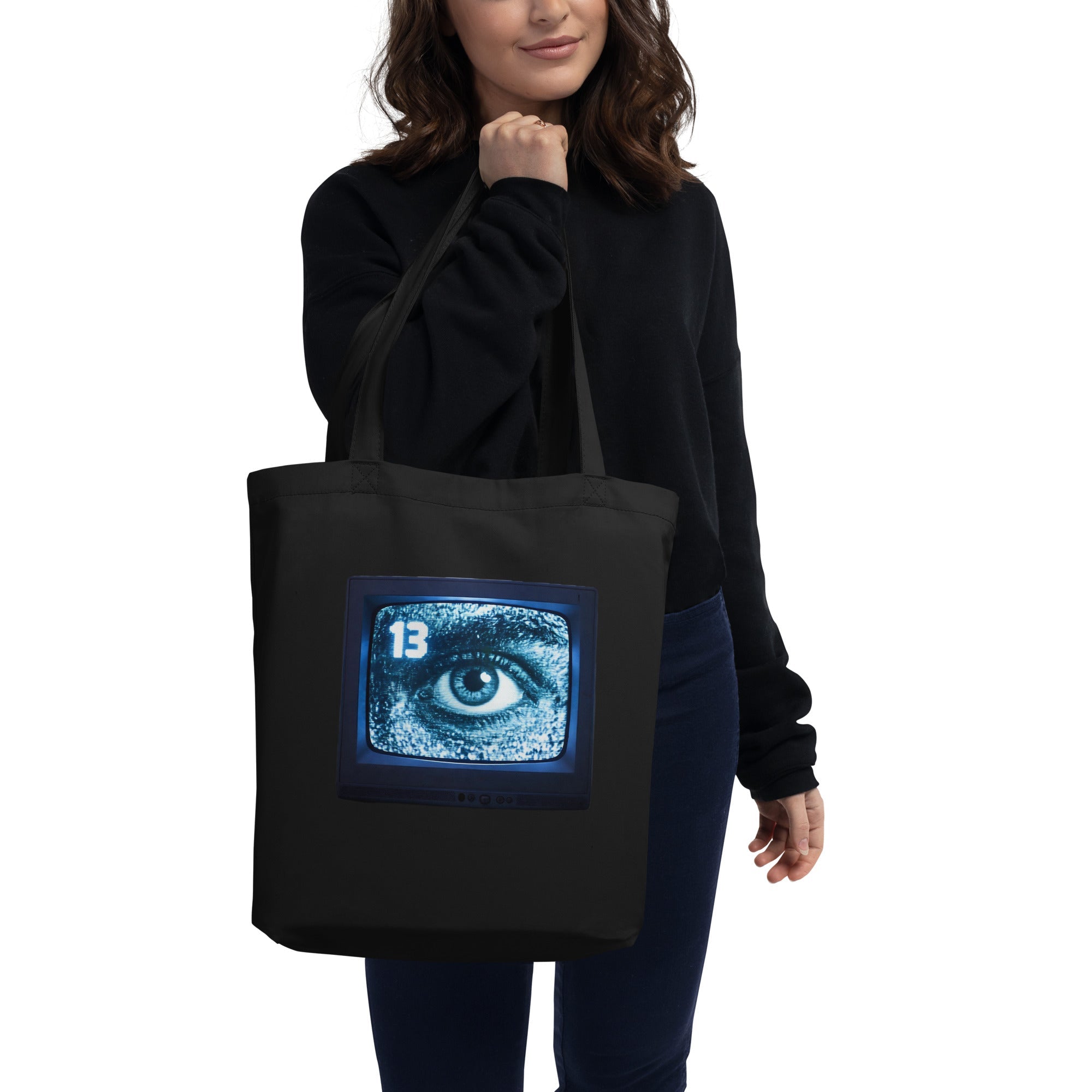 Model wearing Rare Plus Apparel’s “Channel 13 — Stay Tuned for Terror” design, featuring a bright CRT TV with static and an eerie eye on the screen.
