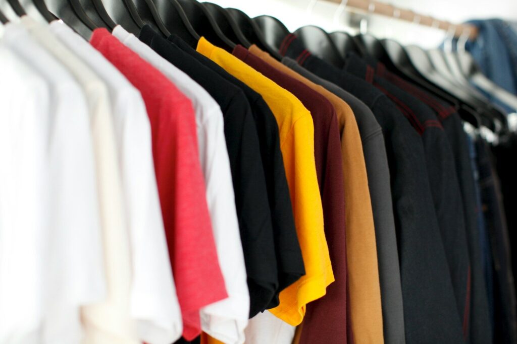 Home - Shop Now at Rare Plus Apparel closeup of hanged shirts on rack